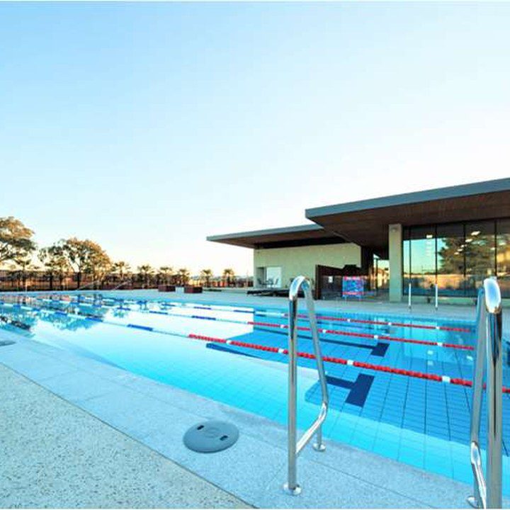 Outdoor pool and clubhouse at Club Trillium at dusk